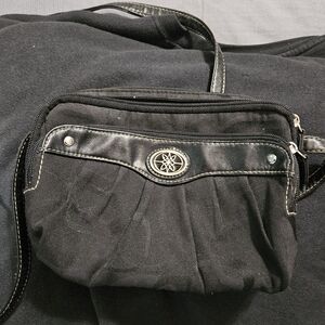Black Crossbody Travel Bag with Decorative Emblem